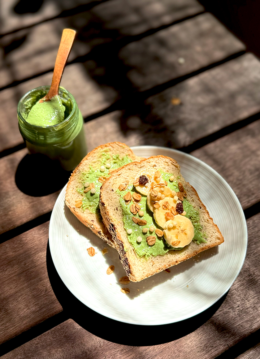 Healthy snack: Vegan Pandan Kaya on a toast with fruits and oats.
