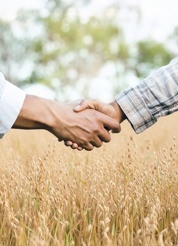 Partnership handshake representing food manufacturing collaboration